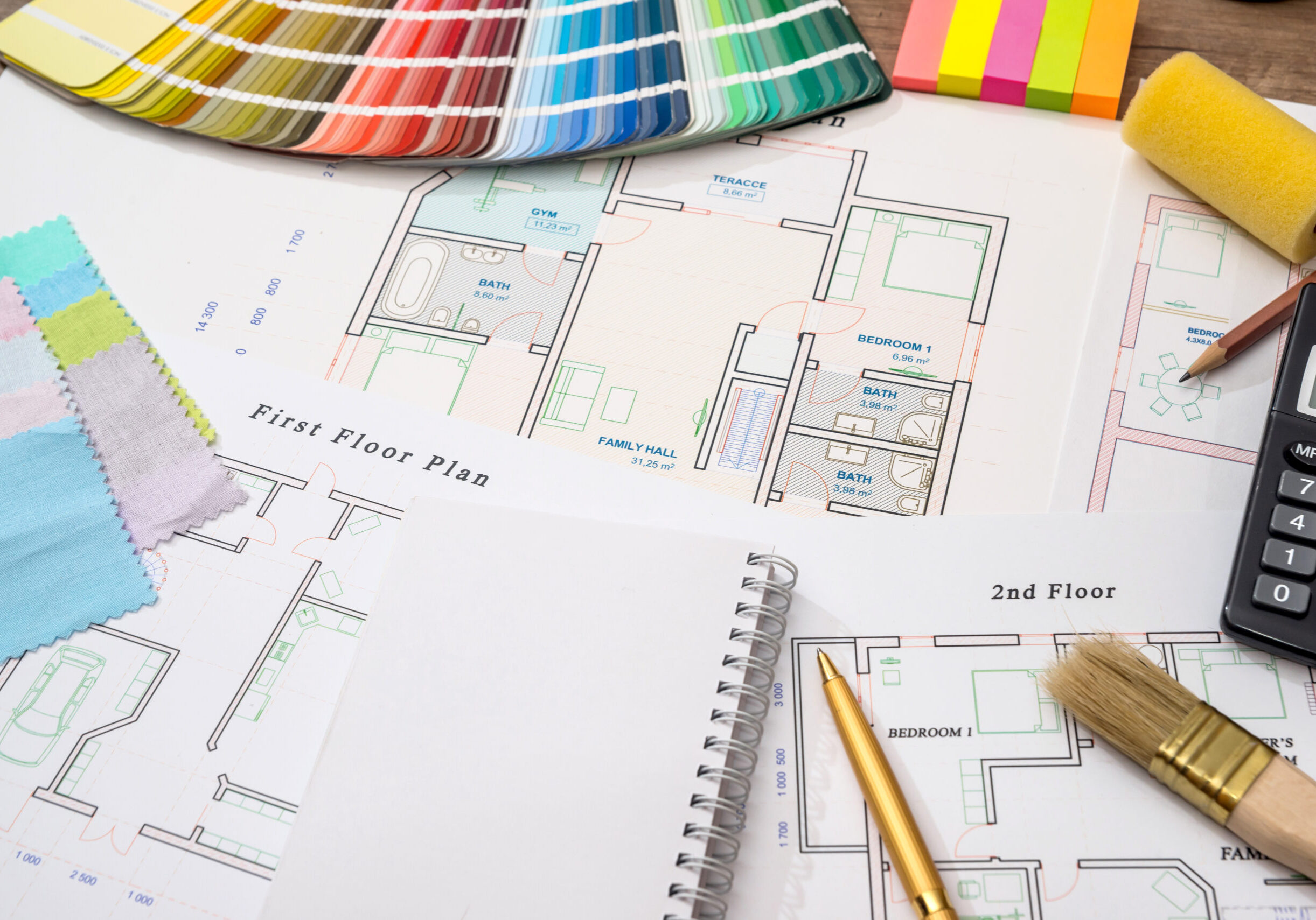 Color samples with house plan, calculator and pen